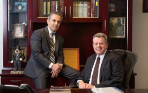 Omrani and Taub in the office smiling