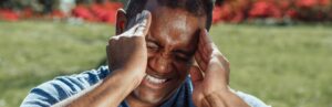 man holding his head from headache