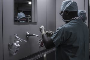 doctors in scrubs washing their hands