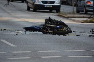 motorcycle totaled lying on its side on the street