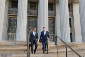 omrani and taub walking down courthouse steps