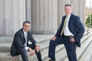 personal injury lawyers omrani and taub standing on stairs of courthouse