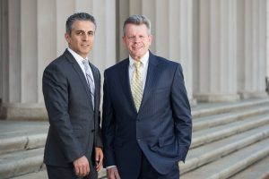 Omrani and taub smiling on court steps