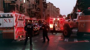 ambulance vehicles blocking a city street after injury
