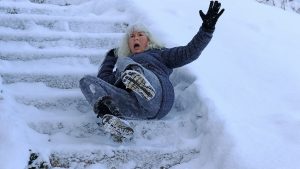 woman slipping down stairs on icy staircase