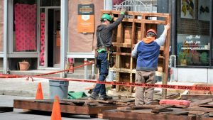 construction workers putting up a pallet