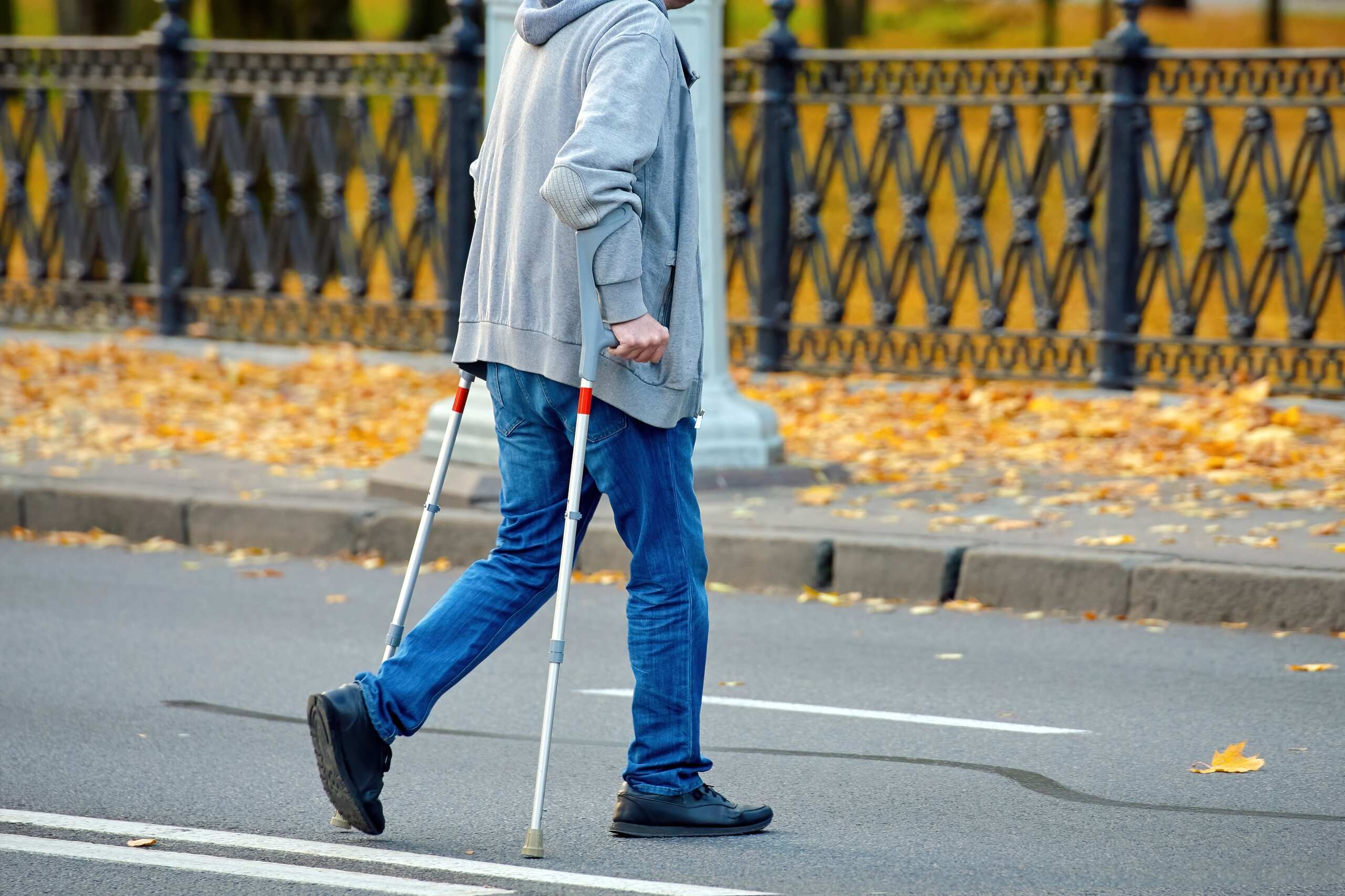 Pedestrian crossing a Manhattan street mid-block, illustrating that while jaywalking is legal in NYC, it doesn't guarantee a win in court.