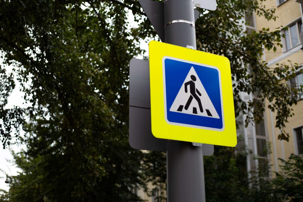 Pedestrian crossing sign in New York highlighting right of way protections under NYC law