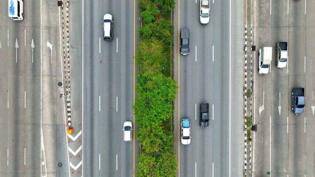 Aerial view of NYC traffic showing vehicles in multiple lanes, illustrating the environment where lane splitting and filtering occur.