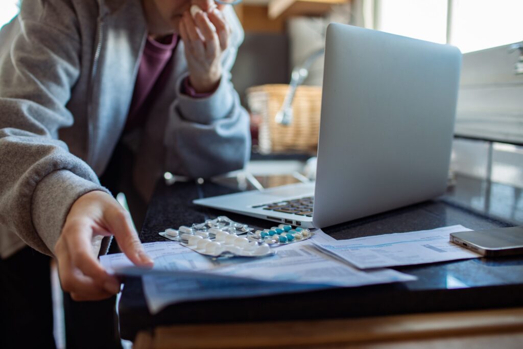 Injured cyclist reviewing medical expenses and no-fault insurance paperwork after a New York bicycle accident