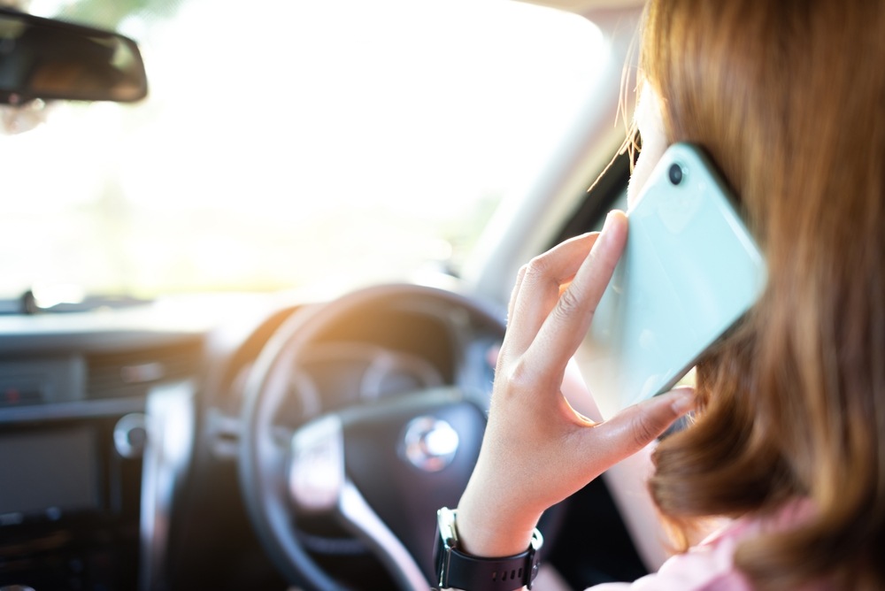 Driver talking on a cell phone while driving, a leading cause of distracted driving accidents in New York