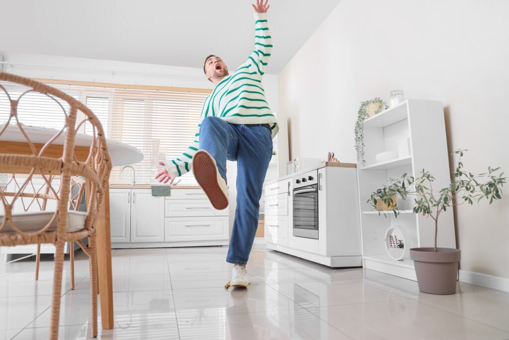 A person slipping on a sleek floor depicts common hazards causing Apartment Lobby and Stairwell Falls in NYC.