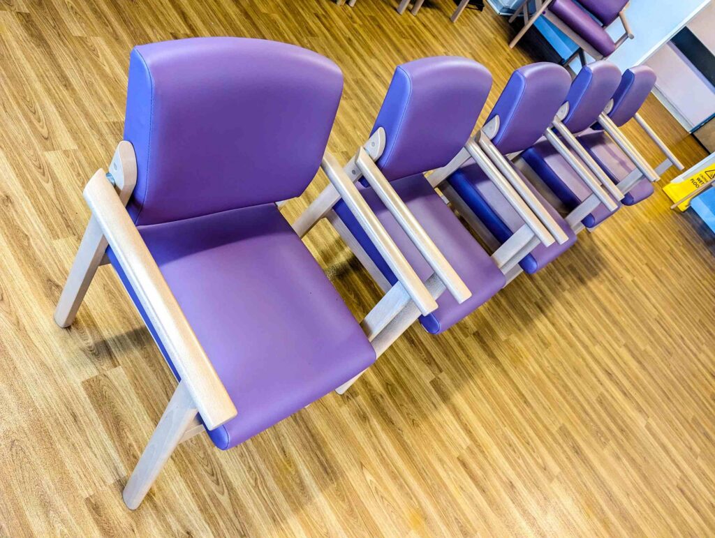 A row of purple chairs in a medical waiting room where a failure to diagnose cancer in New York can occur.