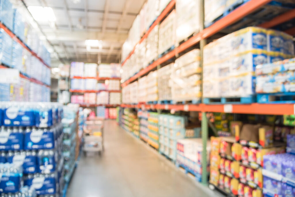 A blurred warehouse store aisle where a slip and fall at big box stores in New York can happen.